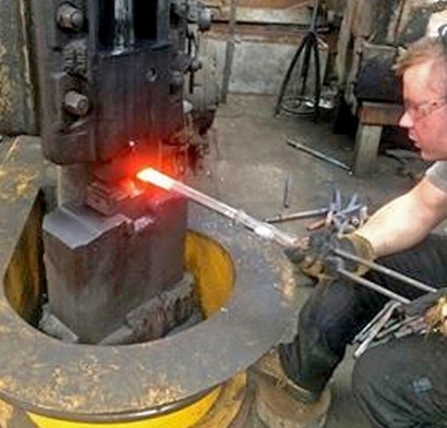Metal worker working with a machine